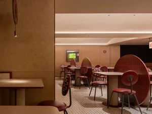 Modern industrial restaurant interior with metal tables and chairs
