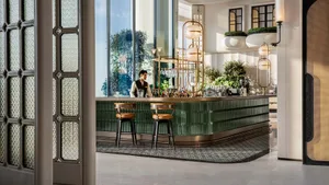 A modern bar with a mid-century design featuring metal and glass materials.