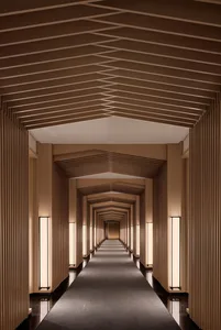 A modern corridor with wooden paneling and a long, straight path.