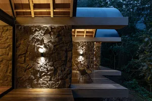 Modern exterior business design featuring stone and concrete materials.