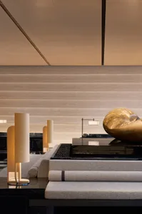 Modern hotel lobby featuring contemporary design with mixed materials including concrete and wood.