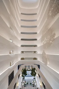 Modern hotel lobby with white marble, glass, and metal accents