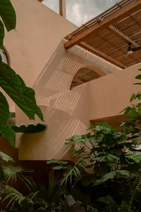 Modern interior design featuring clay walls and wooden beams.
