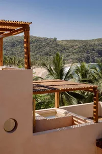 Modern outdoor living space featuring a pool deck with sandstone, concrete, and wood elements.