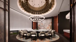 Modern restaurant interior featuring circular glass chandeliers, white chairs with black legs, and a large circular table.