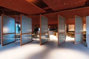 Glass-paneled partitions in a modern restaurant interior