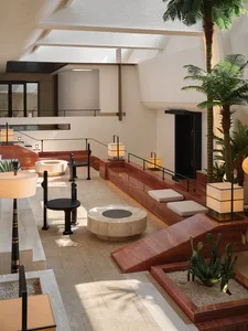 Modern lobby interior featuring marble and concrete materials, with seating arrangements and decorative plants.