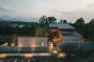 Modern residential home with wooden exterior at dusk
