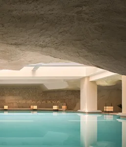 Swimming pool interior with a modern design featuring concrete walls and ceiling.