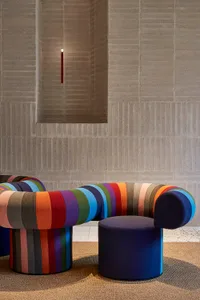 A modern, colorful sofa with an organic, wave-like shape