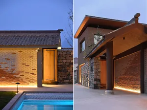 A modern entranceway featuring concrete, brick, and stone materials.