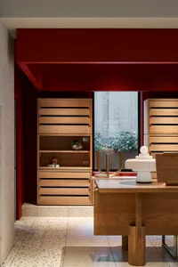 Modern office retail space with wooden shelves and concrete features.
