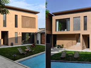 Modern residential exterior with concrete walls, large windows, and a swimming pool.