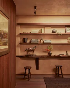 A set of wooden floating shelves adorned with books, vases, and other decorative items.