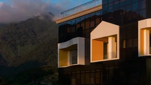 Modern high-rise building featuring large glass windows and concrete structural elements.