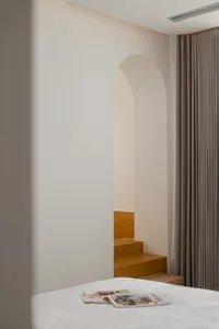 A minimalist interior with concrete walls and wooden elements.