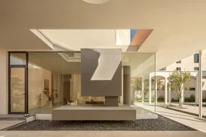 A minimalist living room with modern materials, featuring sleek lines and a neutral color palette.