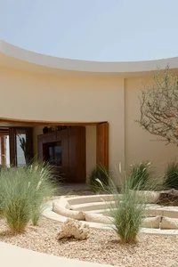 Minimalist residential interior design featuring a simple, open-plan layout with clay flooring.