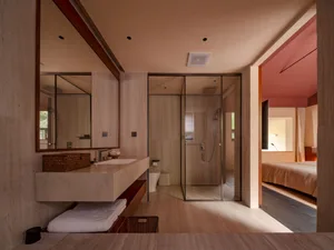 A modern bathroom featuring minimalist design with tile walls and floor.