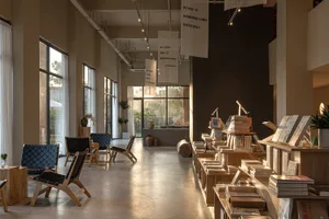 A modern bookstore with concrete, timber, and glass interior design.