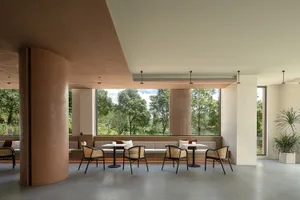 A modern cafeteria space featuring a combination of concrete and wooden materials with a clean, minimalist design.