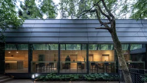A modern coffee shop with glass walls and wooden features.