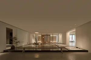 Modern hotel lobby featuring a concrete floor, minimalist design, and open space.