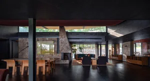 Interior design of a modern living room featuring stone walls and concrete flooring.