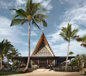 A modern residential exterior featuring architectural design and wooden elements.