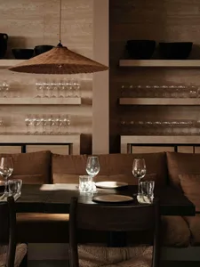 A cozy restaurant interior featuring wooden decor and industrial design elements.