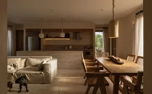 A modern residential living space featuring wooden furniture and natural lighting.