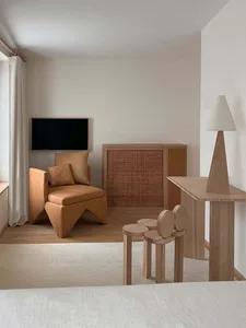 A minimalist living room with wood furniture and a small wooden table.
