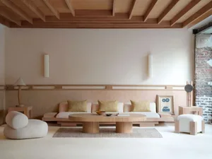 A modern living room with minimalist wooden furniture and white walls.