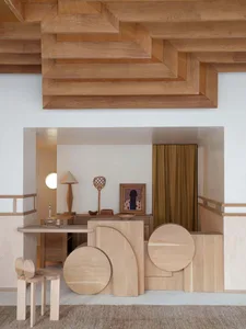 Modern interior design featuring geometric wooden furniture and a mix of natural and industrial materials.