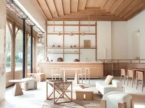 A modern minimalist cafe bar with wooden interiors and bar counter.