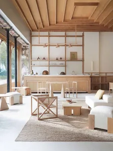 A modern, minimalist residential interior featuring wooden furniture, shelves, and flooring.