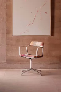 A modern office with a metal-frame chair and upholstered seat and backrest in a business environment.
