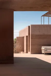 A modern outdoor concrete space featuring minimalistic architecture and a clean, open design.