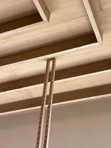 Modern wooden ceiling framing system with exposed beams and structural components.