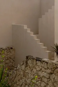 A modern interior space with stone walls and steps