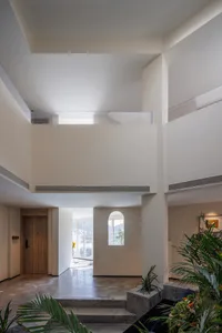 Modern living room interior with concrete flooring and minimalist design.