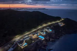 Aerial view of modern residential homes on a cliffside with ocean views.