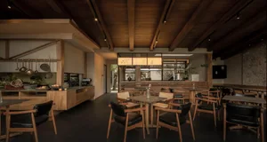 A modern, industrial-style cafe with wooden furniture and decor