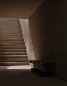 Concrete stairs with warm lighting in a modern interior setting.