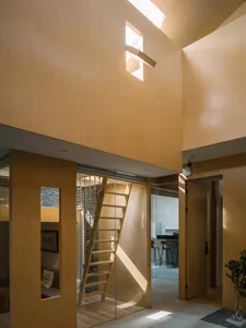 Modern interior design with a wooden ladder, high ceiling, and skylight