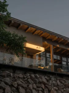 Modern restaurant exterior with wooden structures and warm lighting