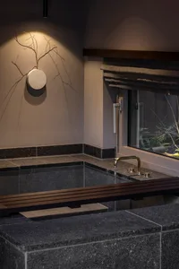 Modern stone bathroom with minimalist design and natural light.