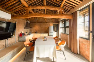 Industrial-style residential kitchen featuring natural wood elements and minimalistic design.