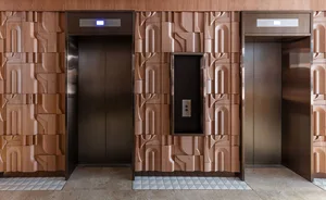 Industrial-style lobby with metal paneling and decorative wall art.