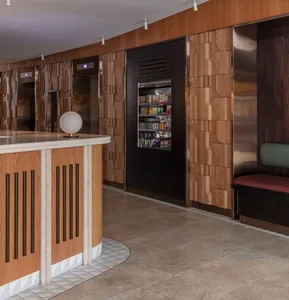 A modern coffee shop featuring wooden paneling with a variety of products on display.